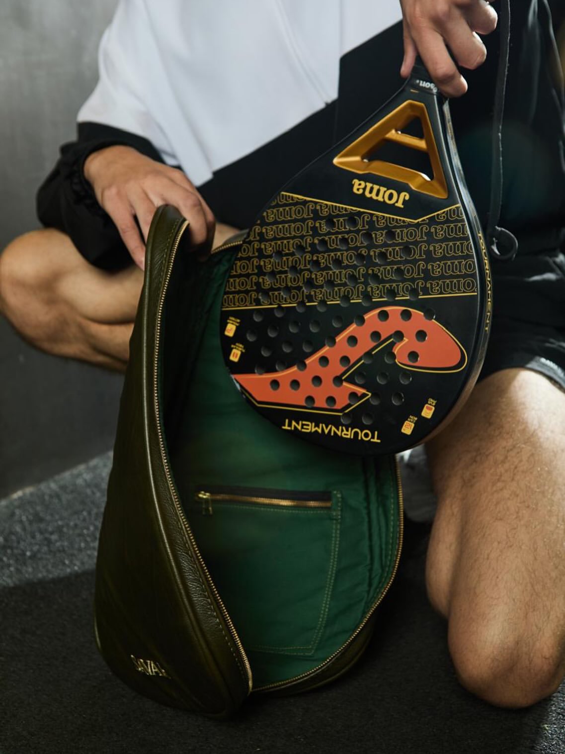 Irish green Savari leather padel bag holding a padel racket